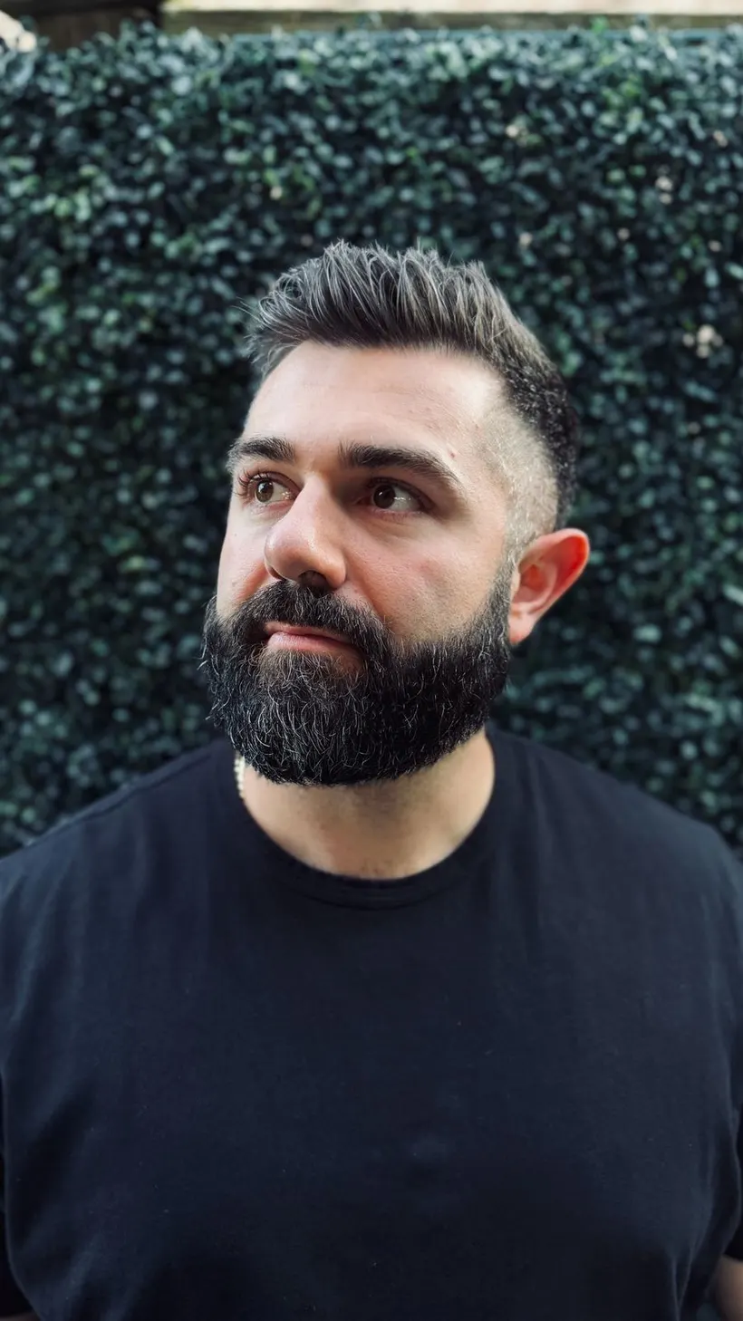 Joshua Palassis looking off to the side, thoughtful